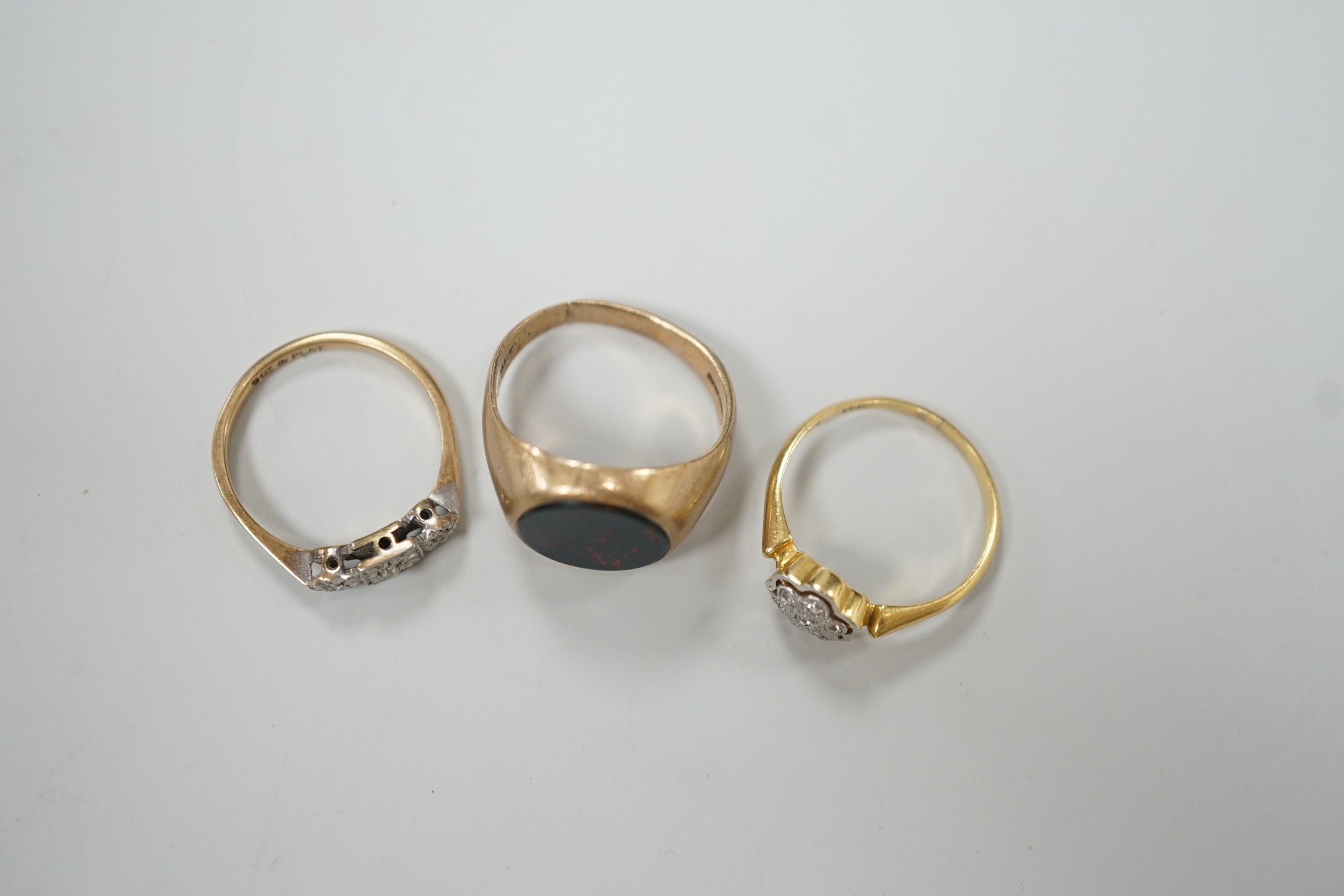 A 1920's 18ct and diamond chip set cluster ring, size N, gross 2.4 grams and two 9ct rings including bloodstone set signet, gross 7.2 grams.